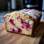 Schnittansicht eines dekadenten wei&szlig;en Schokoladen-Himbeer-Kuchens mit Himbeeren und wei&szlig;er Schokolade.