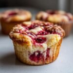 Nahaufnahme von saftigen Cherry Cheesecake Cupcakes mit Kirschen und cremiger F&uuml;llung.